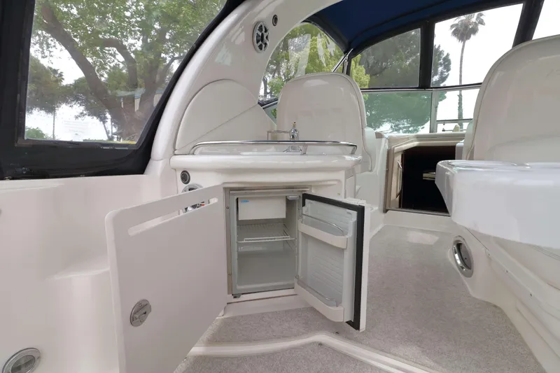 Slide: The Image of Interior of 2004 Sea Ray 340 Sundancer with open mini fridge and sink. - 6