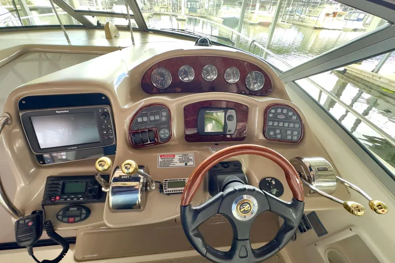 Slide: The Image of Helm of 2004 Sea Ray 340 Sundancer with navigation controls and steering wheel. - 8