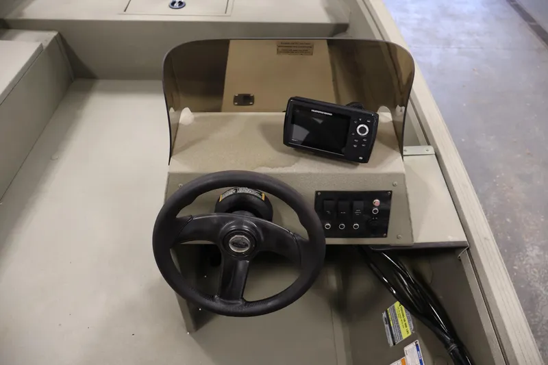 Slide: The Image of 2021 Polar Kraft Sportsman 1760 SE boat dashboard with steering wheel and electronic display. - 24