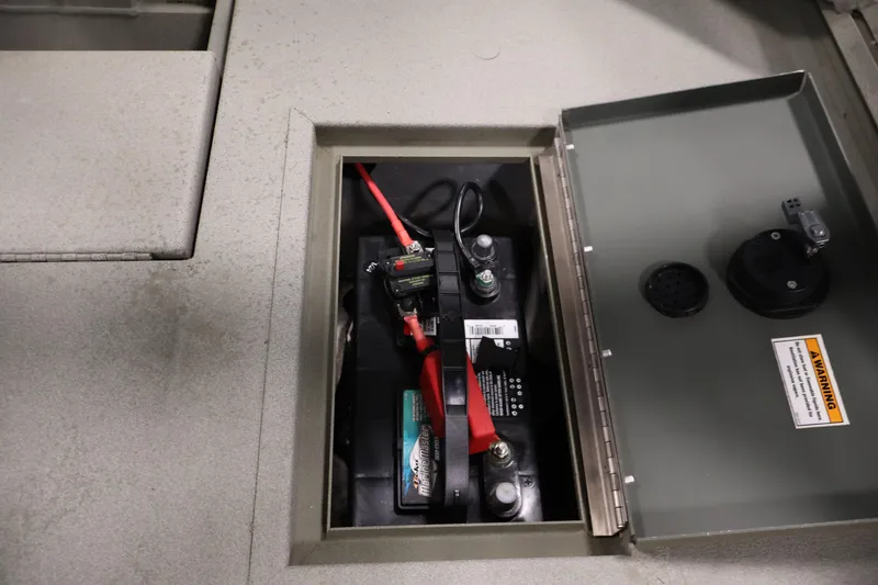 Slide: The Image of Battery compartment of 2021 Polar Kraft Sportsman 1760 SE boat, featuring wiring and warning label. - 34