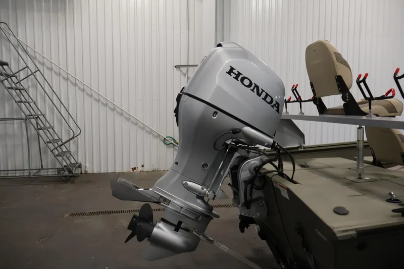 Slide: The Image of 2021 Polar Kraft Sportsman 1760 SE boat with Honda outboard motor in a garage setting. - 38
