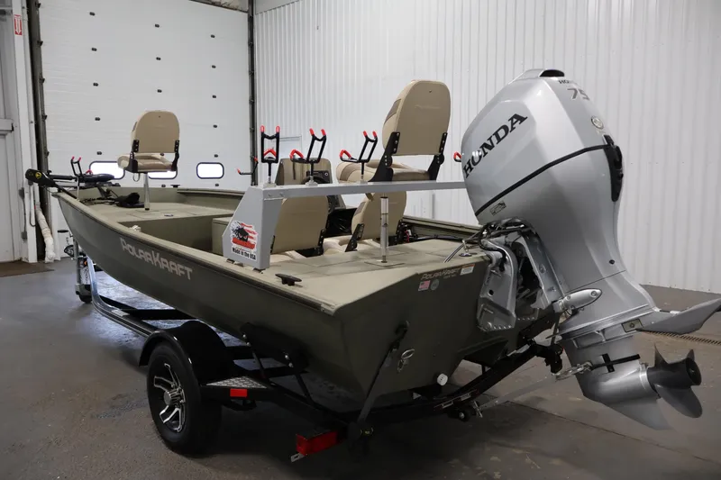 Slide: The Image of 2021 Polar Kraft Sportsman 1760 SE boat with Honda outboard motor in a garage. - 7
