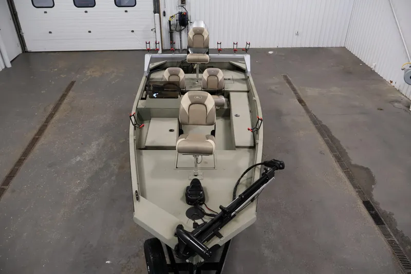 Slide: The Image of 2021 Polar Kraft Sportsman 1760 SE boat in a garage, featuring seating and fishing equipment. - 9