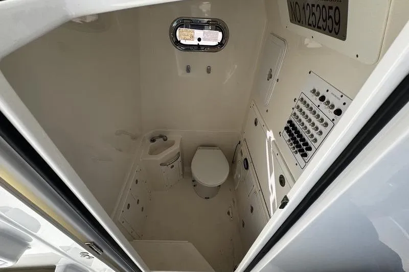 Slide: The Image of Interior of 2013 Edgewater 318CC boat bathroom with toilet and control panel. - 10
