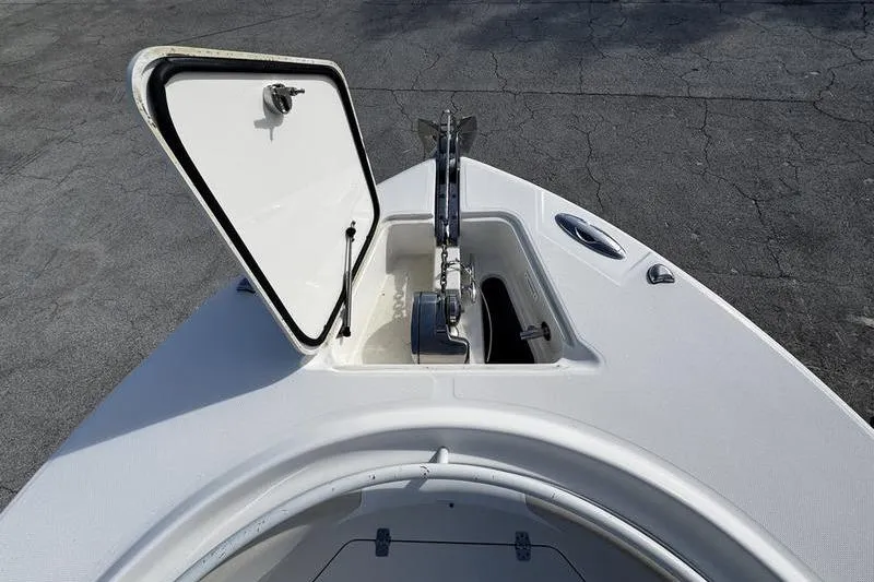 Slide: The Image of Open anchor compartment on 2013 Edgewater 318CC boat, showcasing storage and anchor mechanism. - 20