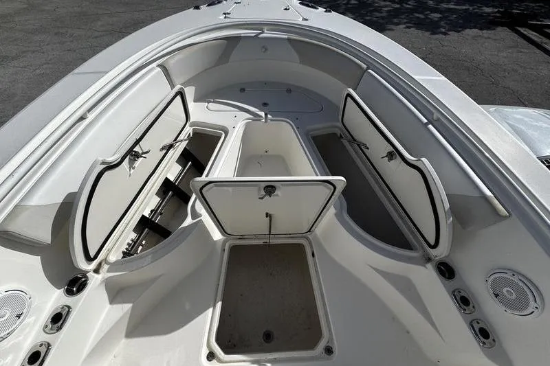 Slide: The Image of 2013 Edgewater 318CC boat interior with open storage compartments. - 23