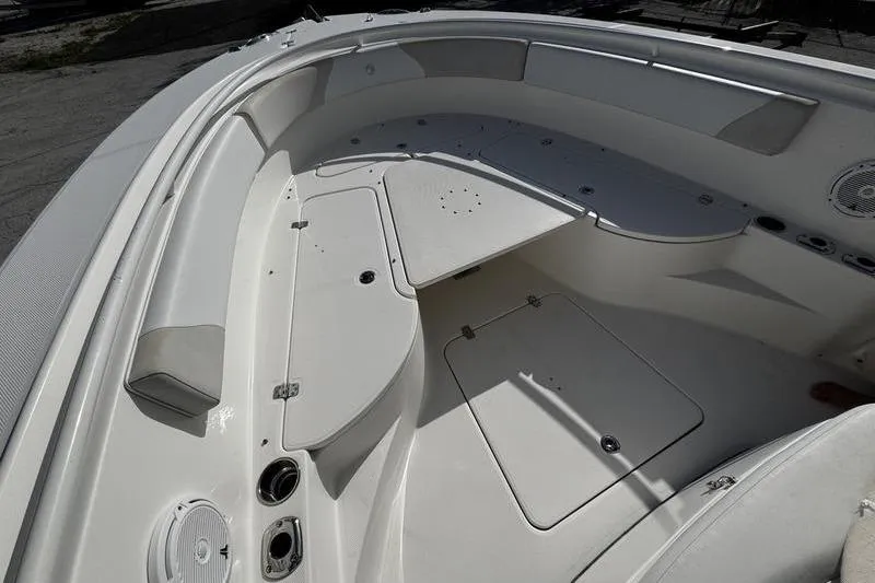 Slide: The Image of 2013 Edgewater 318CC boat interior with seating and storage compartments. - 24