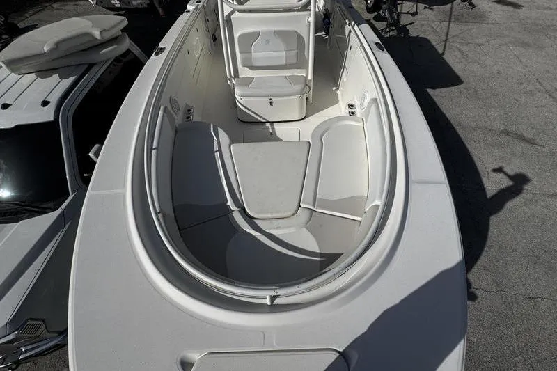 Slide: The Image of 2013 Edgewater 318CC boat interior with seating and console, viewed from above. - 25