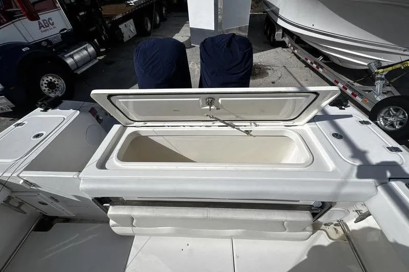 Slide: The Image of Open storage compartment on a 2013 Edgewater 318CC boat deck. - 27