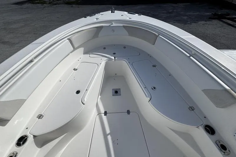 Slide: The Image of 2013 Edgewater 318CC boat interior with spacious deck and storage compartments. - 29