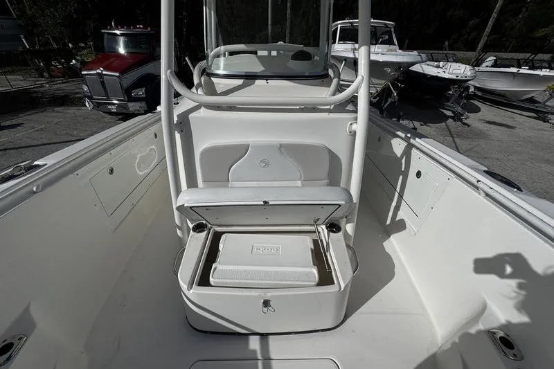 Slide: The Image of 2013 Edgewater 318CC boat interior with open storage compartment and cooler. - 30