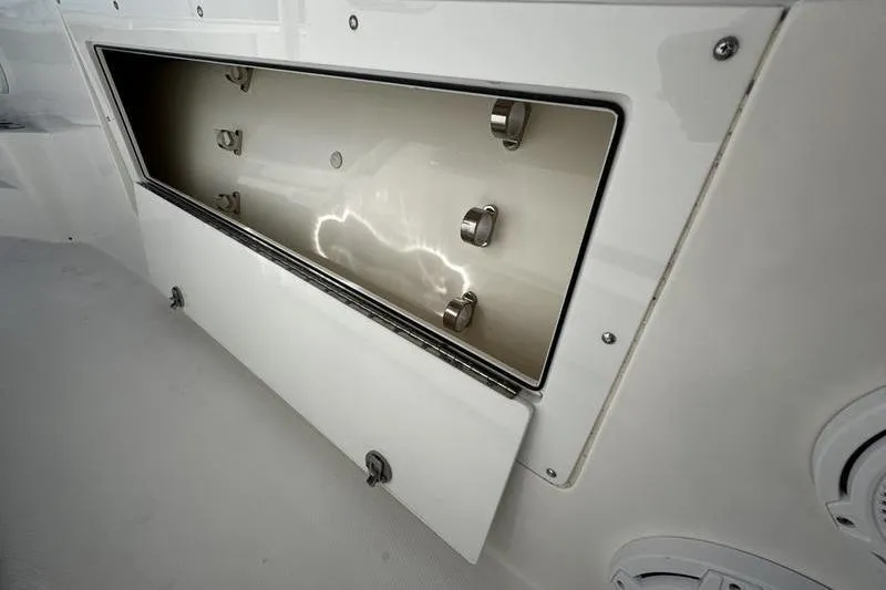 Slide: The Image of Open storage compartment on a 2013 Edgewater 318CC boat, showcasing interior details. - 5