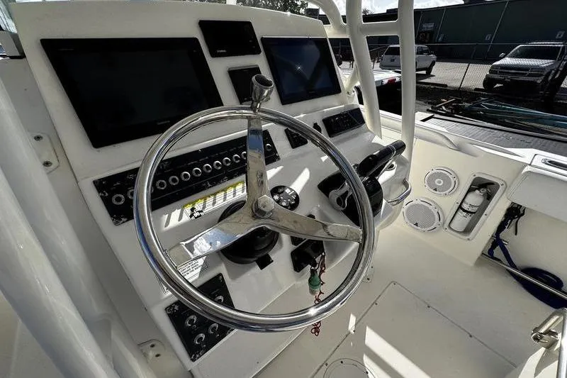 Slide: The Image of Steering console of a 2013 Edgewater 318CC boat with modern controls and displays. - 7