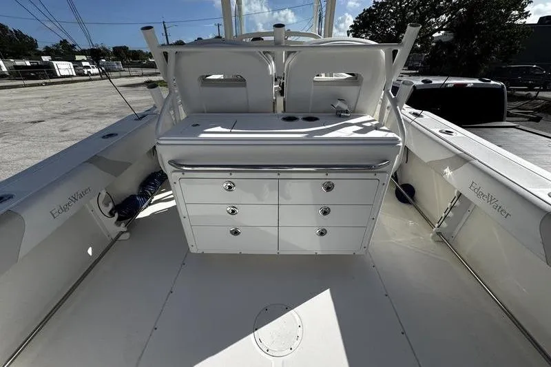 Slide: The Image of 2013 Edgewater 318CC boat interior with storage drawers and seating. - 9