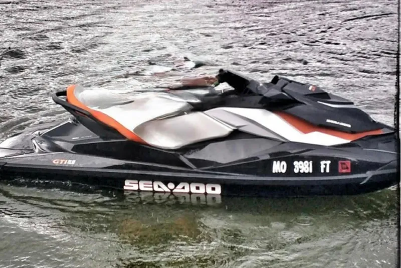 The Image of 2011 Sea-Doo GTI SE 155 jet ski on water, showcasing sleek design and vibrant colors. - 1