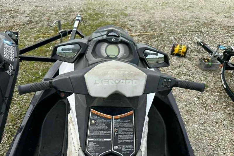 Slide: The Image of 2011 Sea-Doo GTI SE 155 dashboard and handlebars on gravel surface. - 3