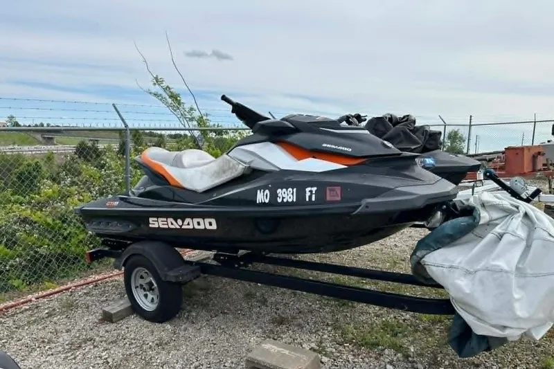 Slide: The Image of 2011 Sea-Doo GTI SE 155 jet ski on trailer, parked outdoors. - 4