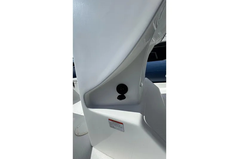 Slide: The Image of 2020 AB Inflatables Oceanus 21 VST interior detail, featuring sleek white design and storage compartment. - 24