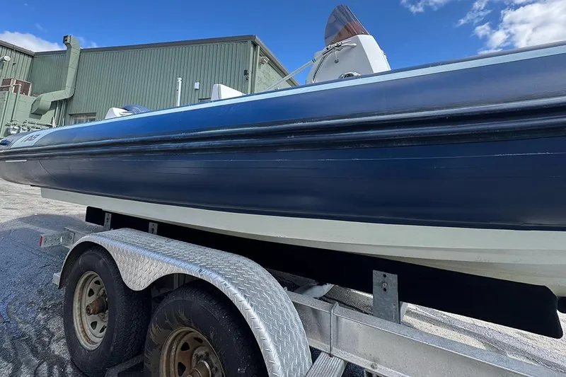 Slide: The Image of 2020 AB Inflatables Oceanus 21 VST boat on trailer, parked outdoors under blue sky. - 7