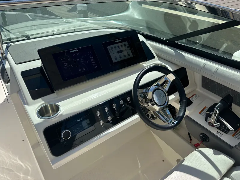 Slide: The Image of 2023 Sea Ray SLX 310 Outboard helm with modern controls. - 15