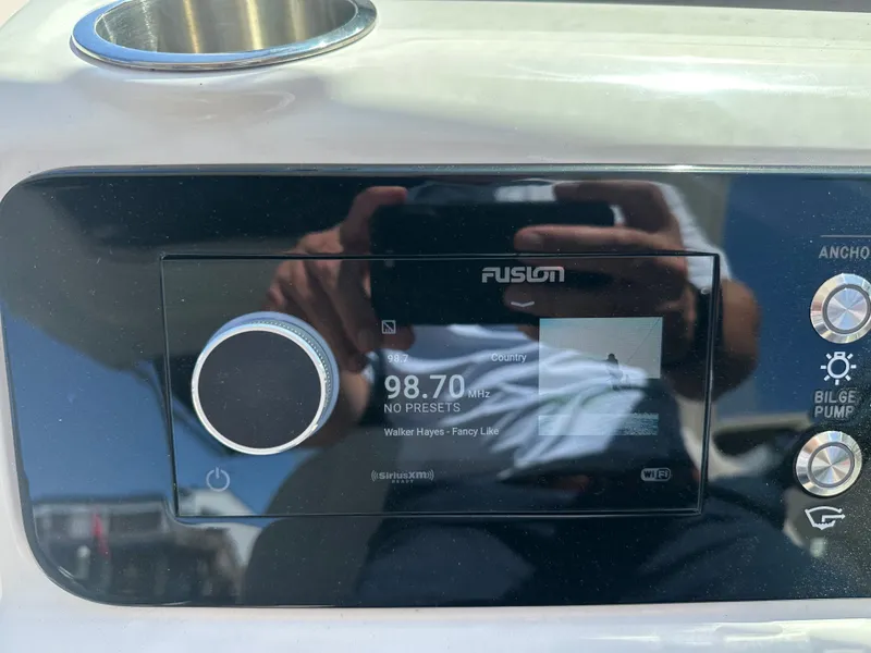 Slide: The Image of Fusion radio on Sea Ray SLX 310 Outboard 2023, displaying 98.7 MHz. - 20