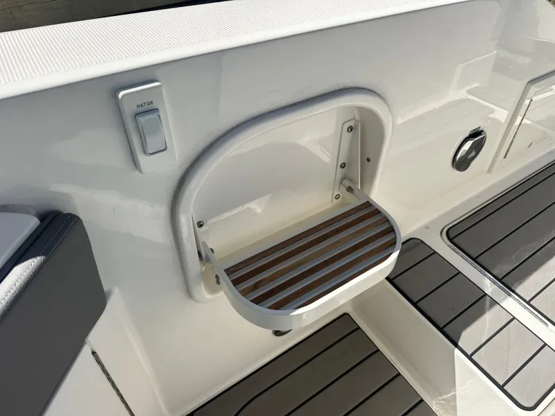 Slide: The Image of 2023 Sea Ray SLX 310 Outboard boat deck with foldable step. - 22