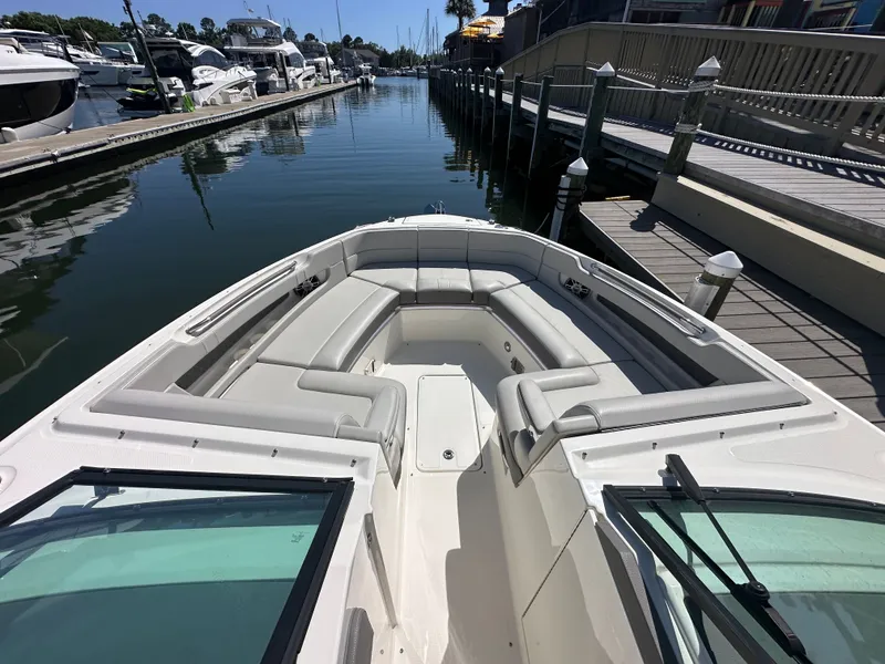 Slide: The Image of 2023 Sea Ray SLX 310 Outboard at marina, luxurious bow seating area. - 23
