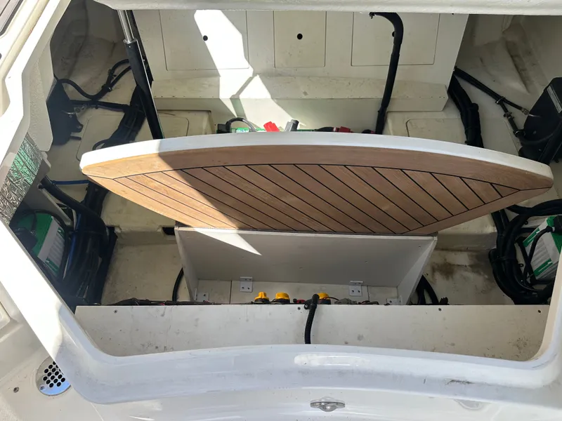 Slide: The Image of Interior of 2023 Sea Ray SLX 310 Outboard with open hatch. - 26
