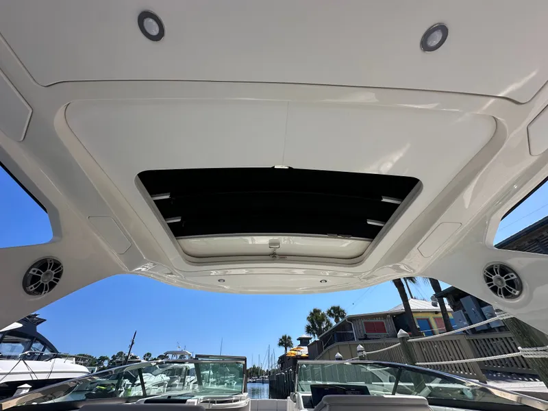 Slide: The Image of Interior view of 2023 Sea Ray SLX 310 Outboard with open roof. - 32