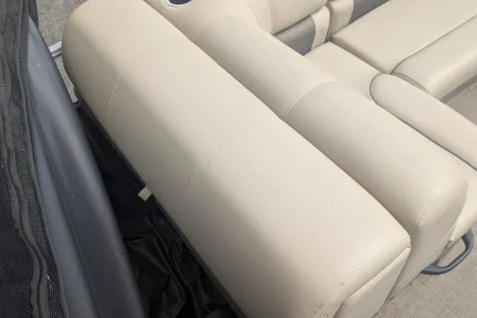 Slide: The Image of 2022 Sun Tracker Fishin' Barge 20 DLX beige seating detail, showcasing comfortable upholstery. - 10