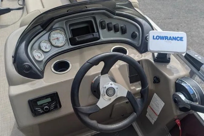 Slide: The Image of 2022 Sun Tracker Fishin' Barge 20 DLX dashboard with steering wheel and Lowrance GPS. - 3