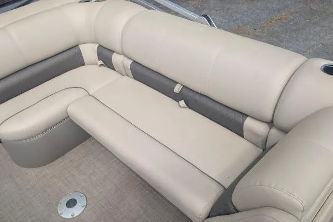 Slide: The Image of 2022 Sun Tracker Fishin' Barge 20 DLX interior seating, beige and gray upholstery. - 6