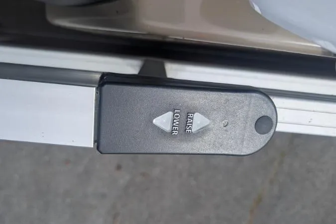 Slide: The Image of Control panel on 2022 Sun Tracker Fishin' Barge 20 DLX for raising and lowering functions. - 8