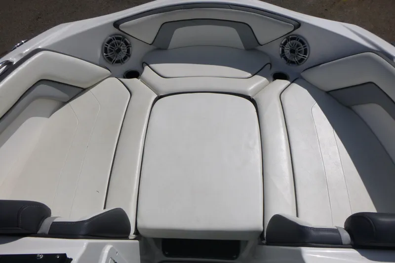 Slide: The Image of 2015 Yamaha Boats SX192 interior seating with white upholstery and built-in speakers. - 10