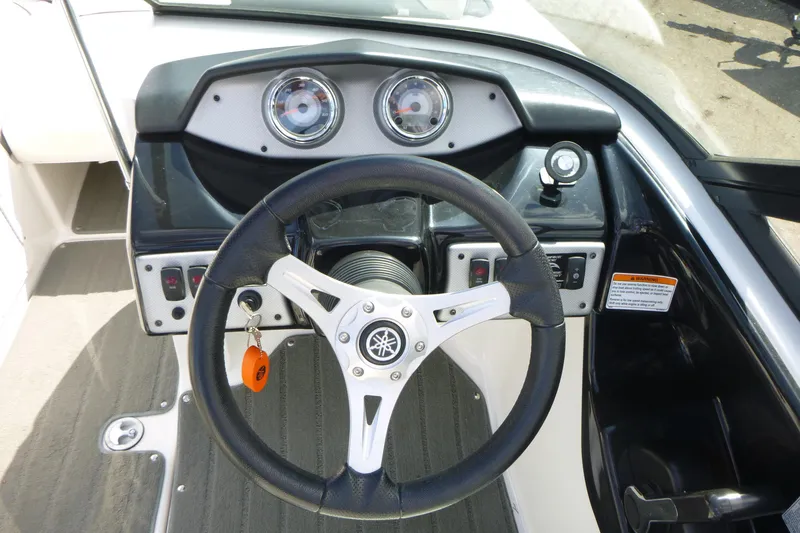 Slide: The Image of Steering wheel and dashboard of 2015 Yamaha Boats SX192, featuring gauges and controls. - 12