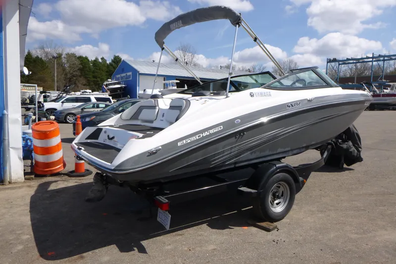 Slide: The Image of 2015 Yamaha Boats SX192 on trailer, parked outdoors under a cloudy sky. - 5
