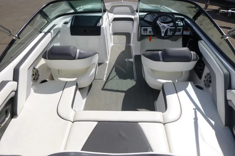 Slide: The Image of 2015 Yamaha Boats SX192 interior with sleek seating and modern dashboard design. - 7