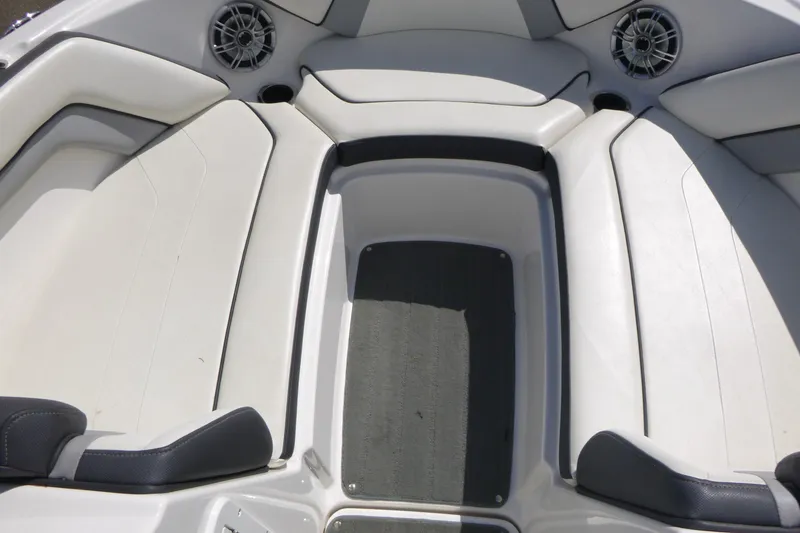 Slide: The Image of Interior seating of a 2015 Yamaha Boats SX192, featuring white upholstery and speakers. - 9