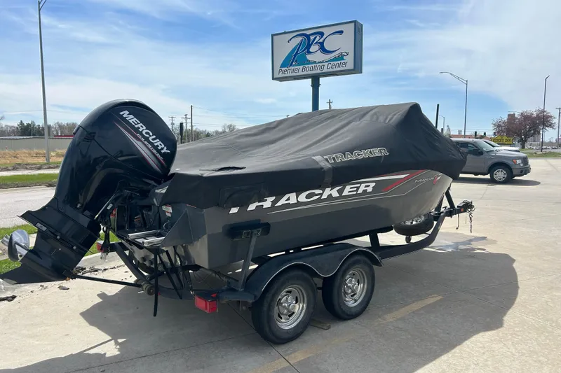 Slide: The Image of 2017 Tracker Targa V-18 Combo boat on trailer, covered, with Mercury engine, at boating center. - 10