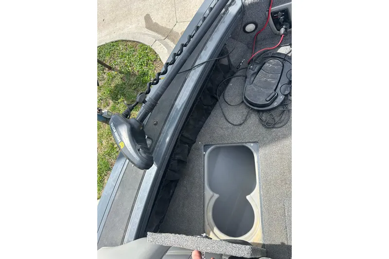 Slide: The Image of 2017 Tracker Targa V-18 Combo boat interior with trolling motor and storage compartment. - 12