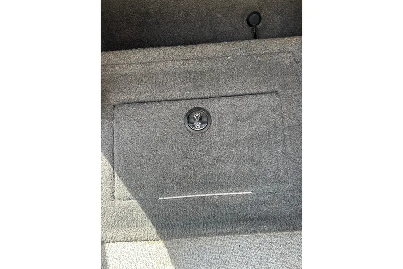 Slide: The Image of Carpeted storage compartment in a 2017 Tracker Targa V-18 Combo boat. - 15