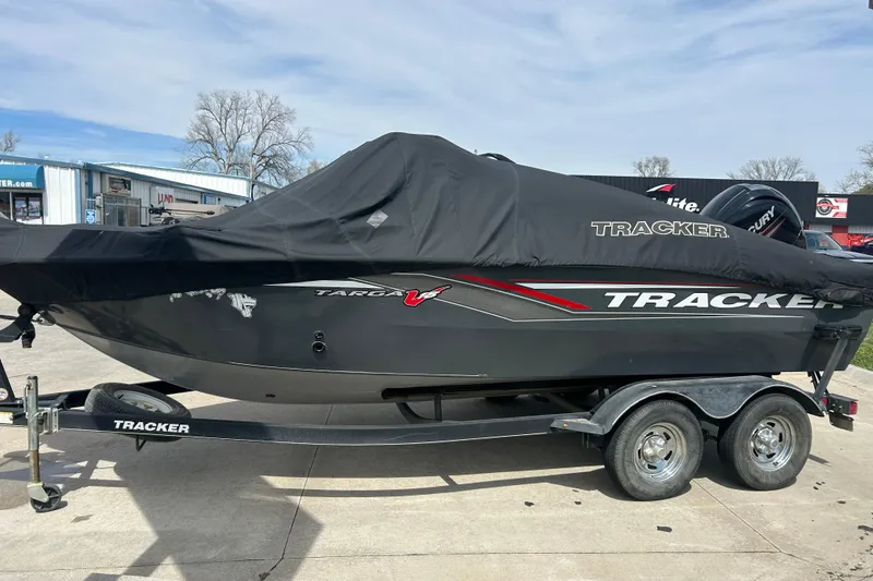 Slide: The Image of 2017 Tracker Targa V-18 Combo boat on trailer, covered and parked outdoors. - 6