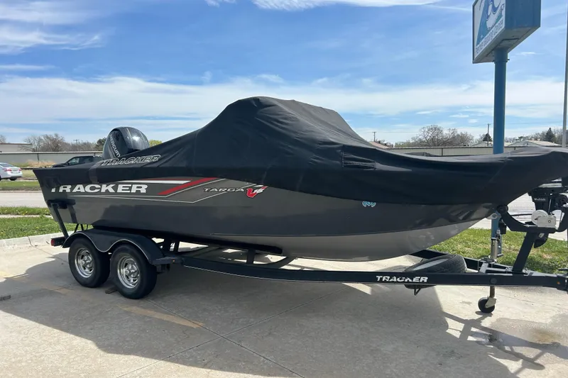 Slide: The Image of 2017 Tracker Targa V-18 Combo boat covered on a trailer in a parking lot. - 8