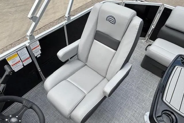 Slide: The Image of 2026 Sun Tracker Party Barge 20 DLX captain's chair with sleek gray upholstery. - 12
