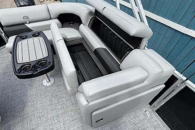 Slide: The Image of 2026 Sun Tracker Party Barge 20 DLX interior with gray seating and table. - 14