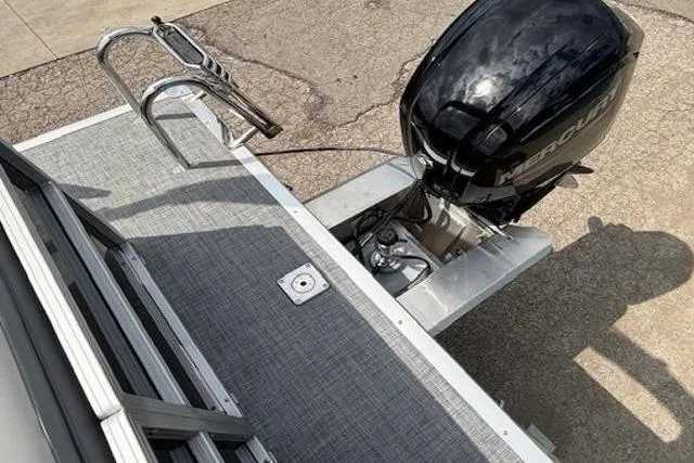 Slide: The Image of 2026 Sun Tracker Party Barge 20 DLX with Mercury outboard motor, rear deck view. - 15