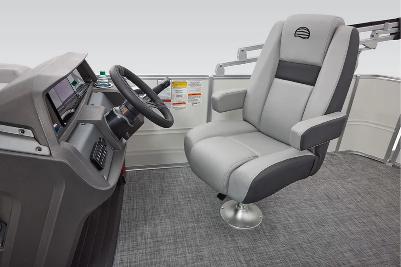Slide: The Image of Manufacturer Provided Image: 2026 Sun Tracker Party Barge 20 DLX helm with plush captain's chair and modern dashboard. - 16