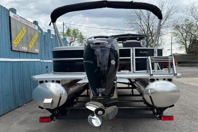 Slide: The Image of 2026 Sun Tracker Party Barge 20 DLX pontoon boat, rear view with motor and canopy. - 4