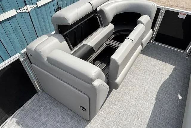 Slide: The Image of 2026 Sun Tracker Party Barge 20 DLX interior with gray seating and storage compartments. - 8