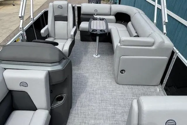Slide: The Image of 2026 Sun Tracker Party Barge 20 DLX interior with gray seating and table. - 9